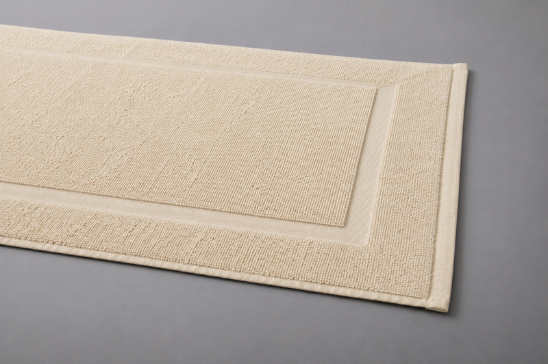 Licht beige katoenen badmat 50x70 cm 850 GSM met geweven rand